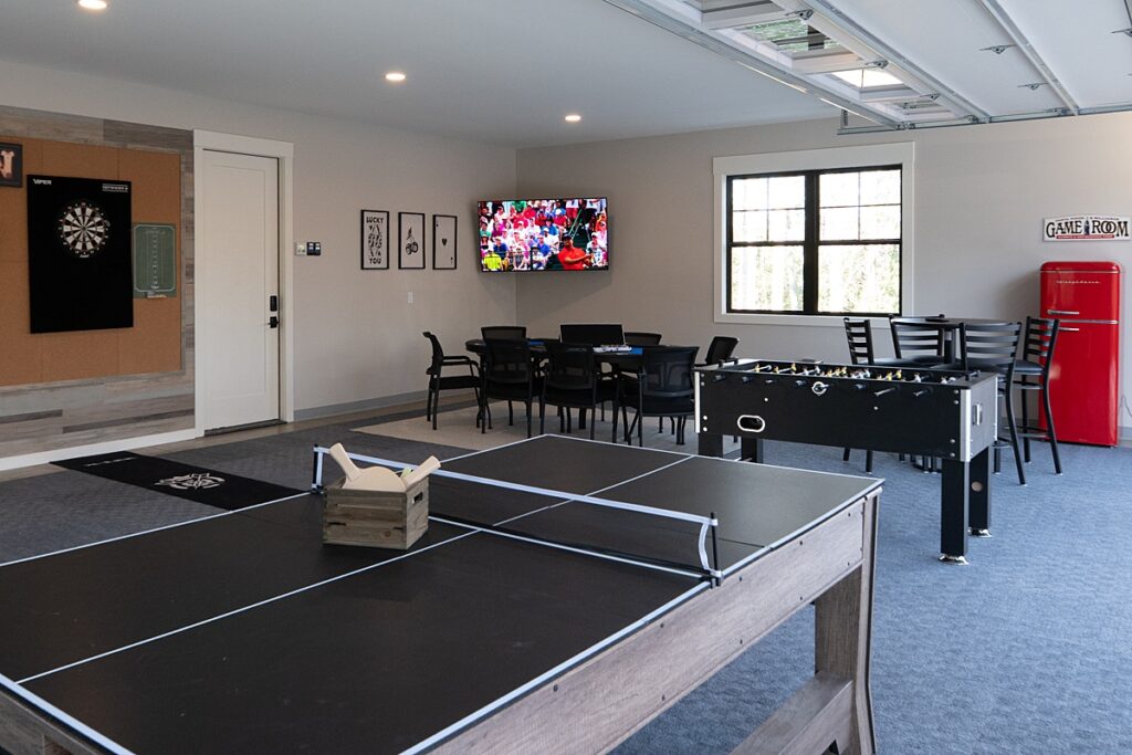 Game room with a ping pong table and seating.