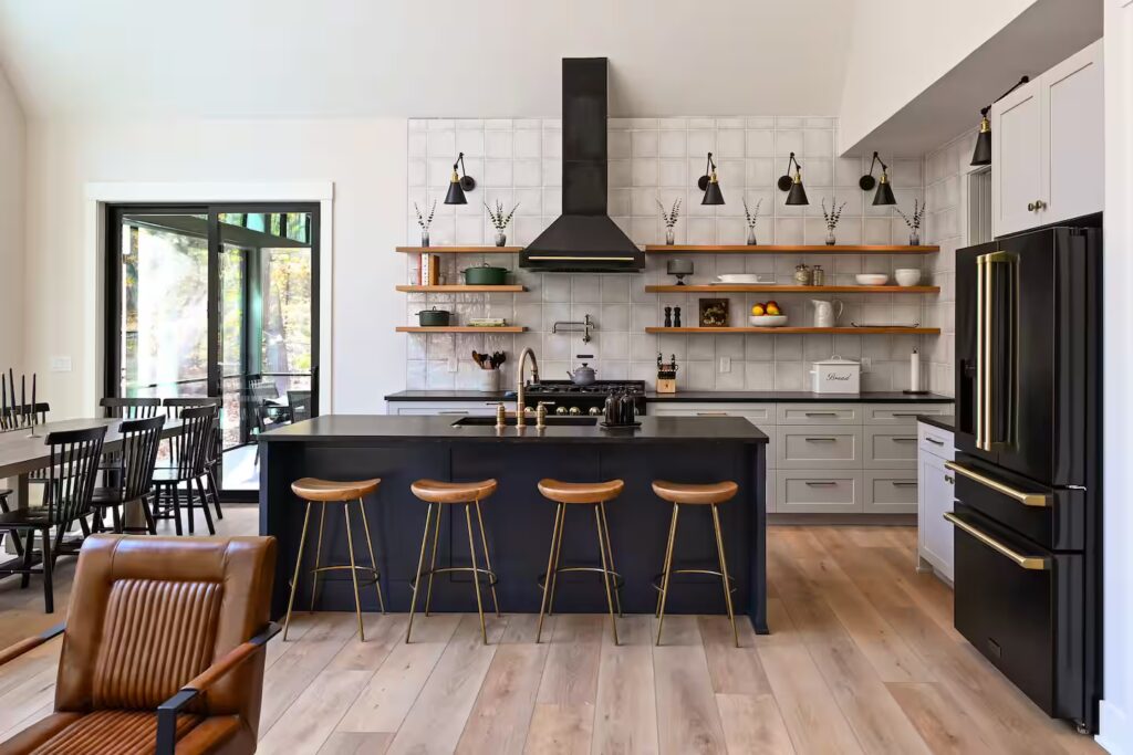Chef kitchen with a long island and bar stools.