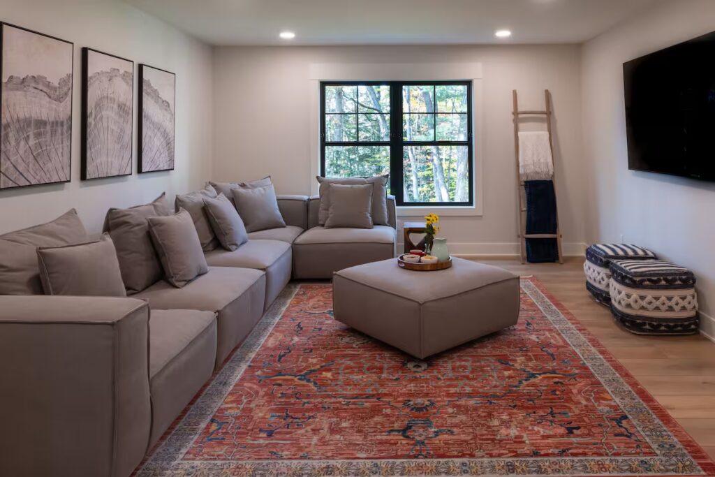 Lounge with deep sectional sofa and a wide window.
