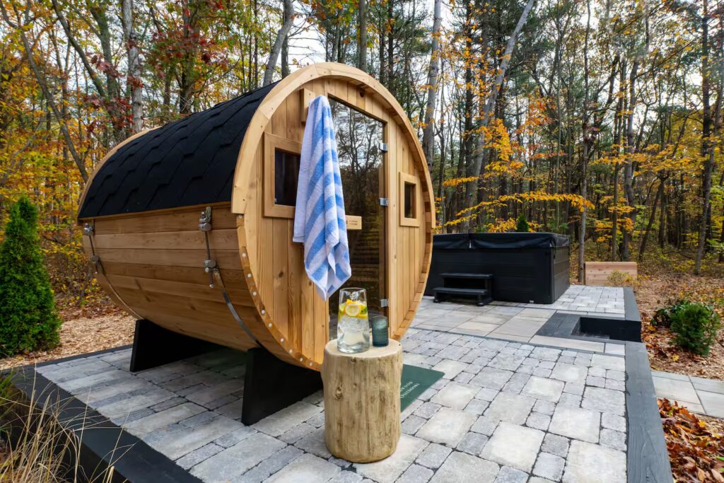 Cedar barrel sauna on the stone patio.